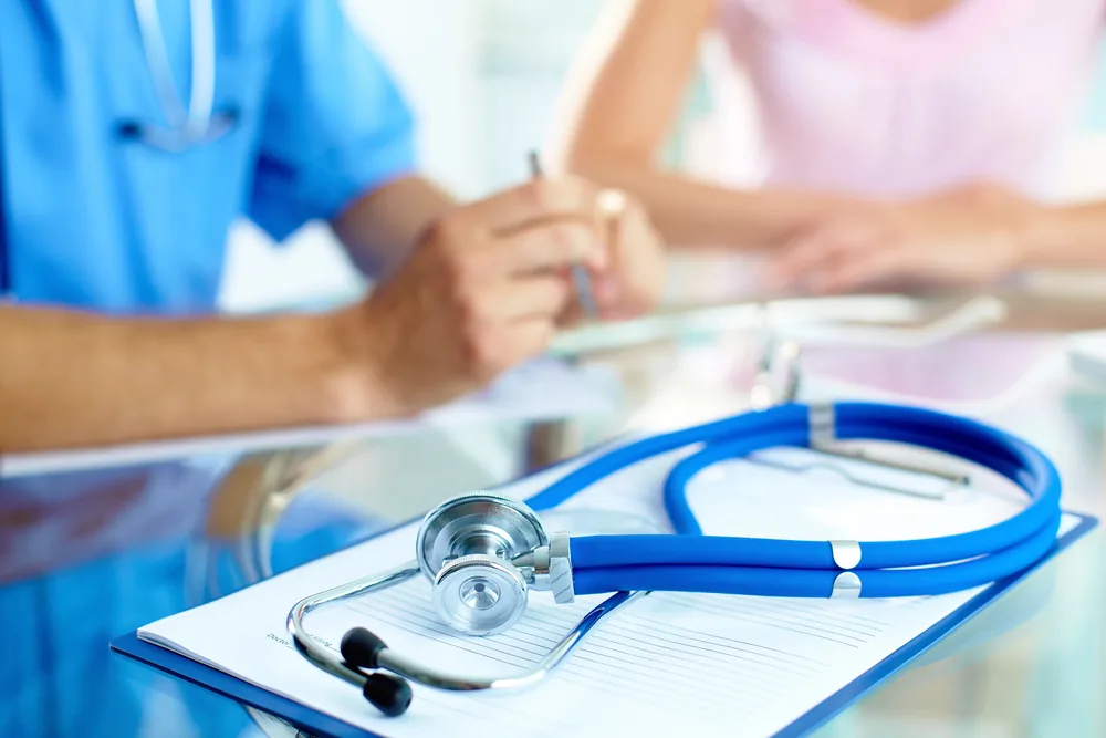 Stethoscope and clipboard indicating a transitions care planning session for a senior patient 