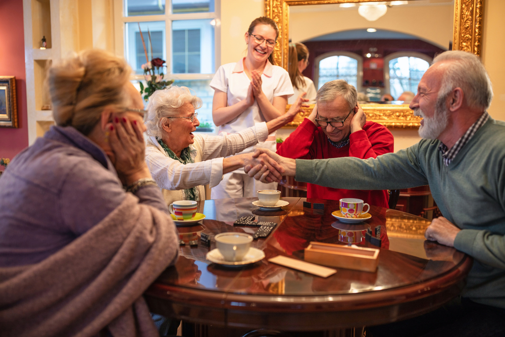 Older folks shaking hands over a game result