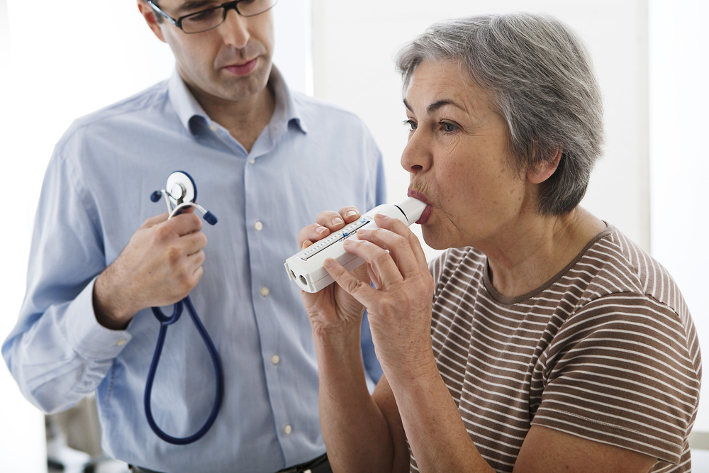Professional from a chronic disease management company assisting a patient.
