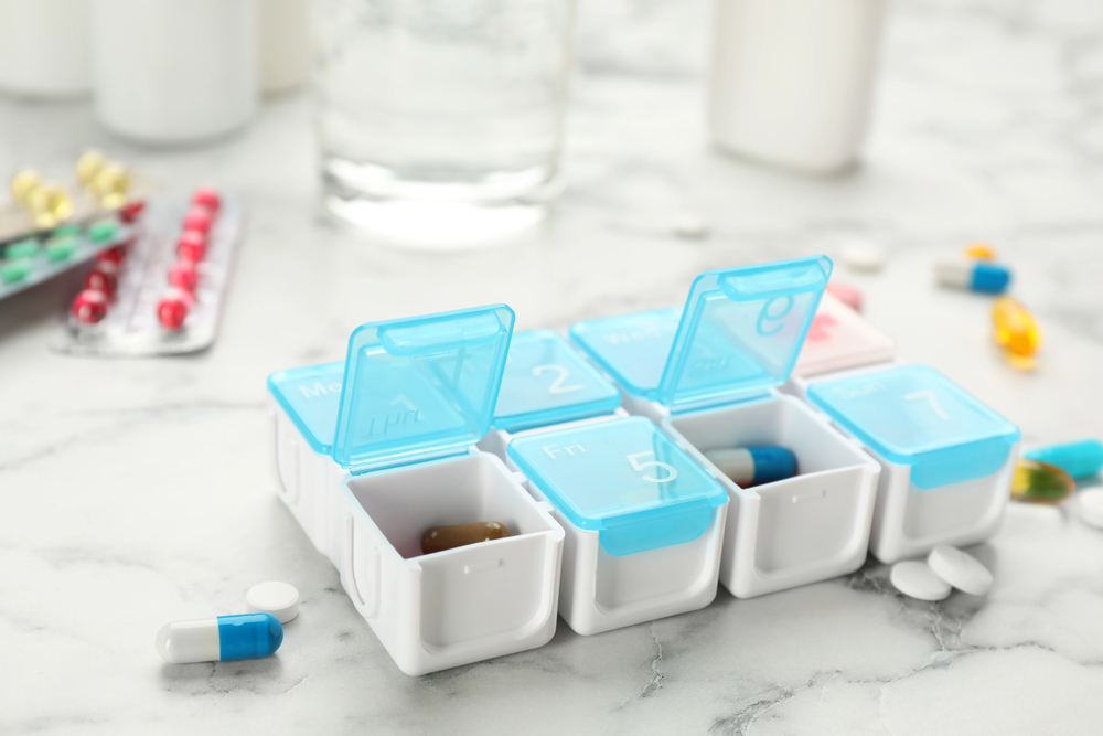 Chronic illness meds being sorted in a box for medication management
