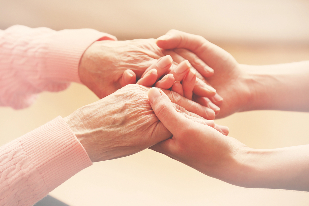 Hands holding to depict crisis care management support