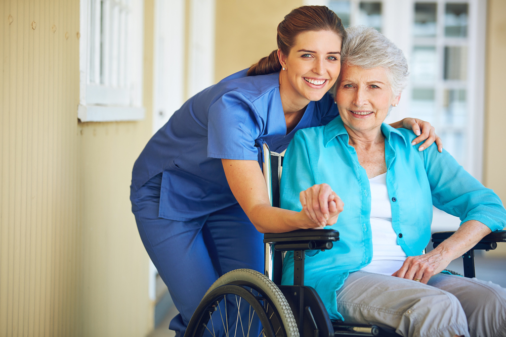 Caregiving so compassionate she feels like part of the family. Portrait of a doctor caring for her senior patient at a nursing home. Senior woman in wheelchair and female hospice nurse.