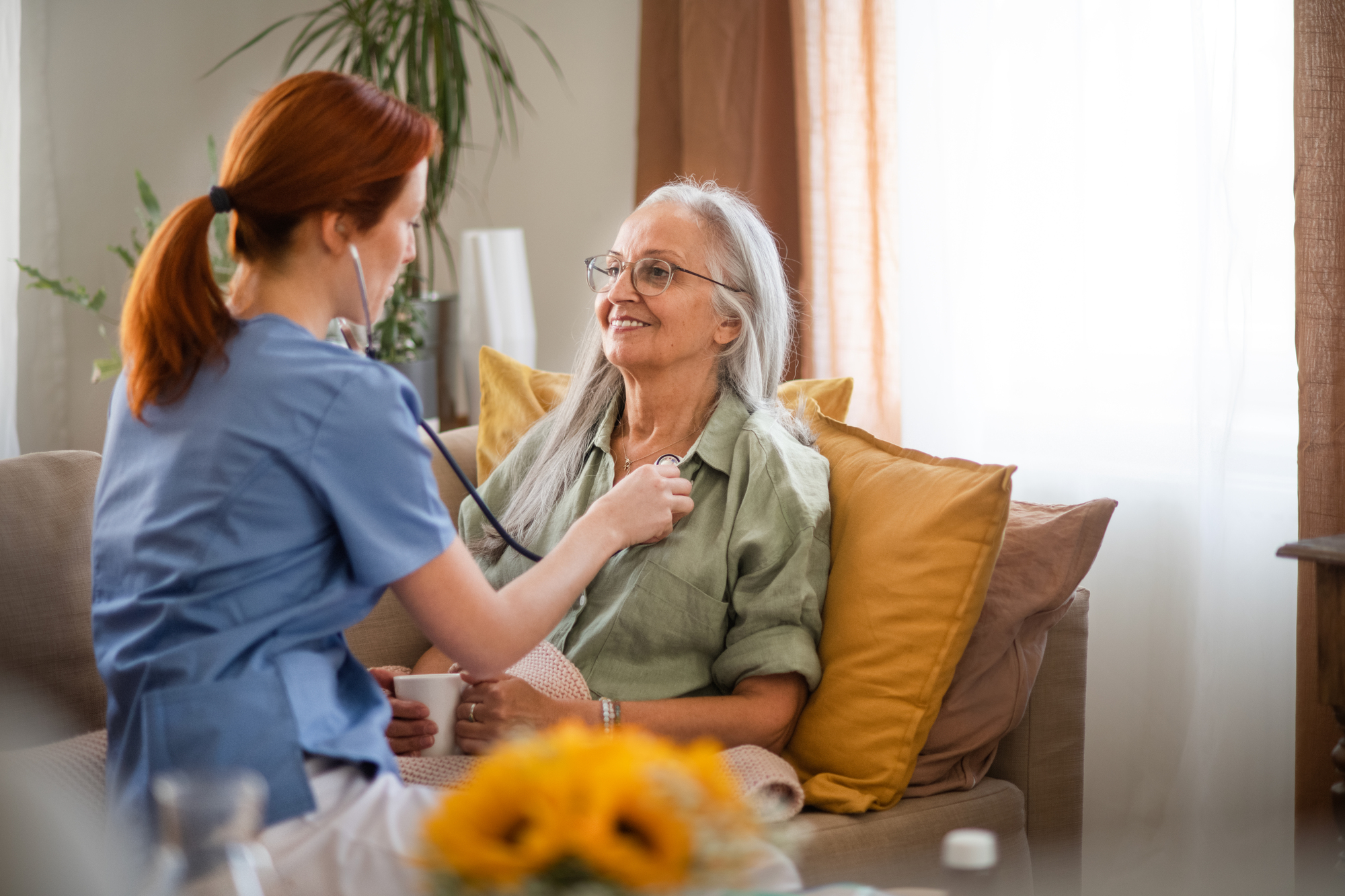 A nurse providing home care as part of a chronic care management planning service.